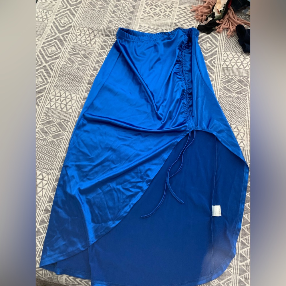 Never worn. Size medium to large. Bright blue adjustable slit skirt.